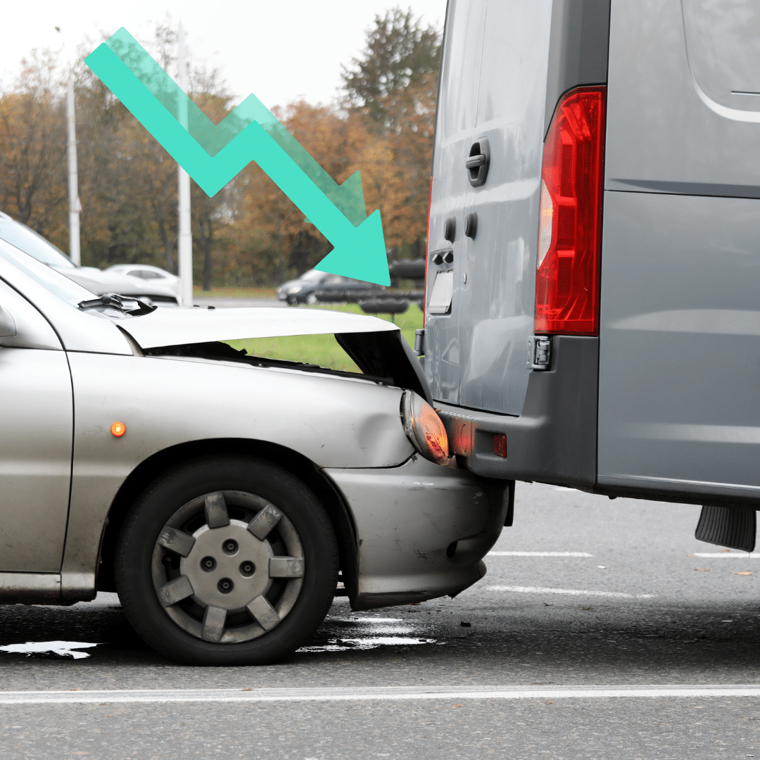 A silver car with a dented hood has collided with the rear of a gray van on a road. An illustrated arrow points from the car to the van, indicating the impact. Trees and other vehicles are visible in the background.